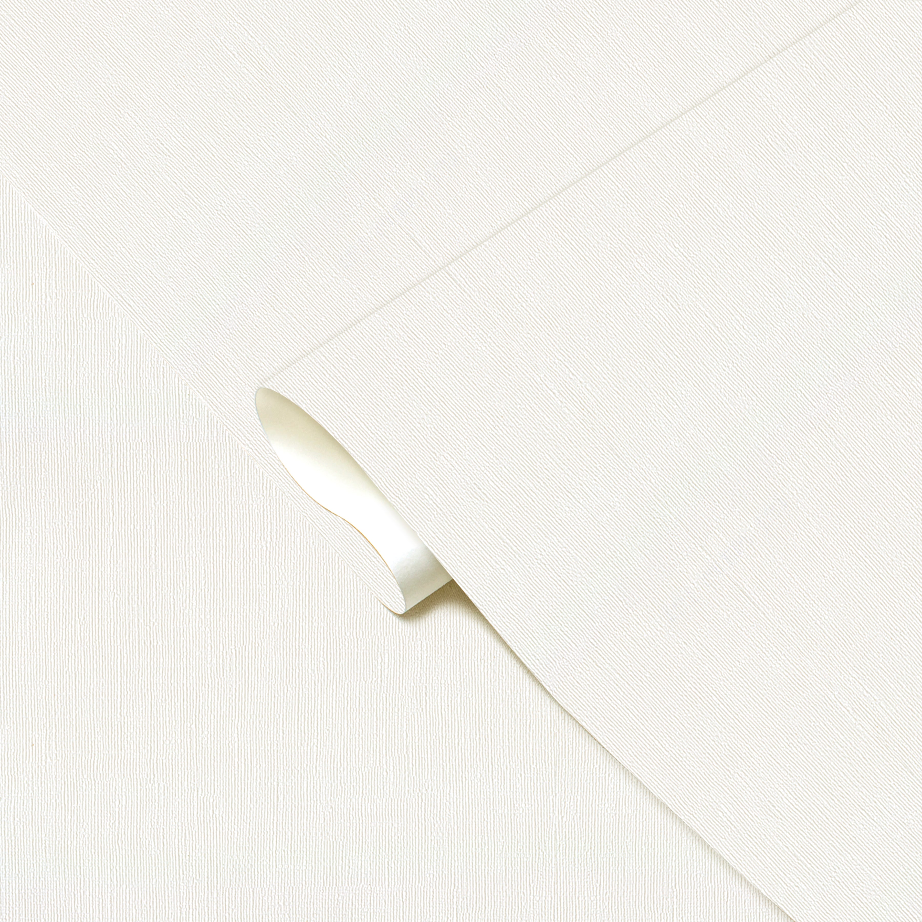 Close-up of a white fabric with a subtle pattern on a light gray background