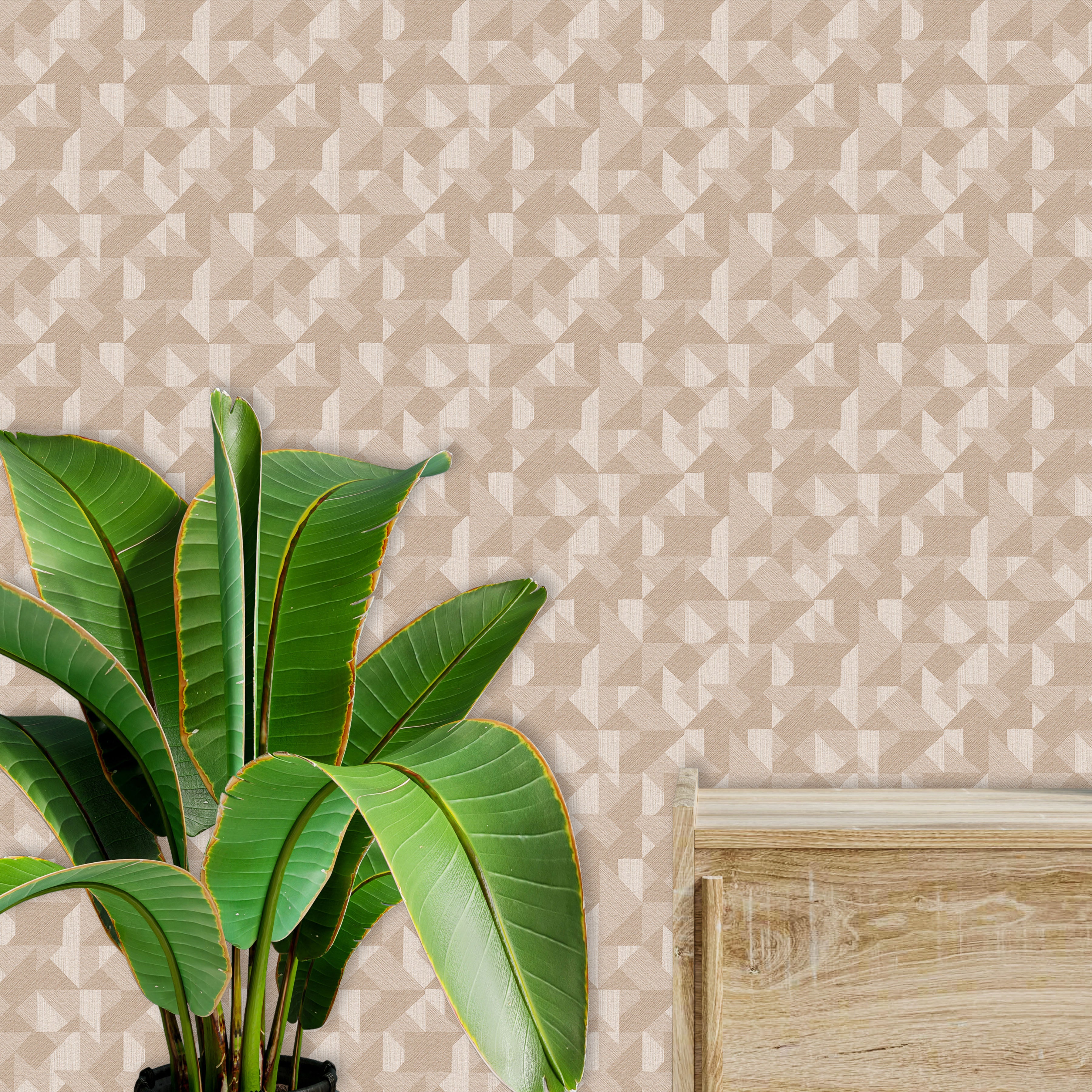 Tropical Plant with Large Green Leaves against a Geometric Beige Wall